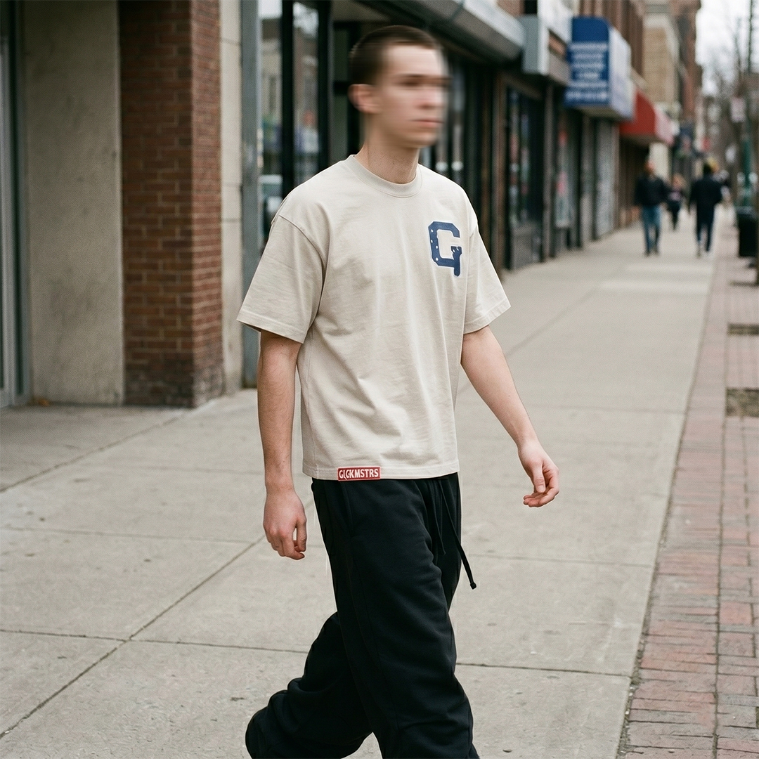 Members Only beige tee on a model walking